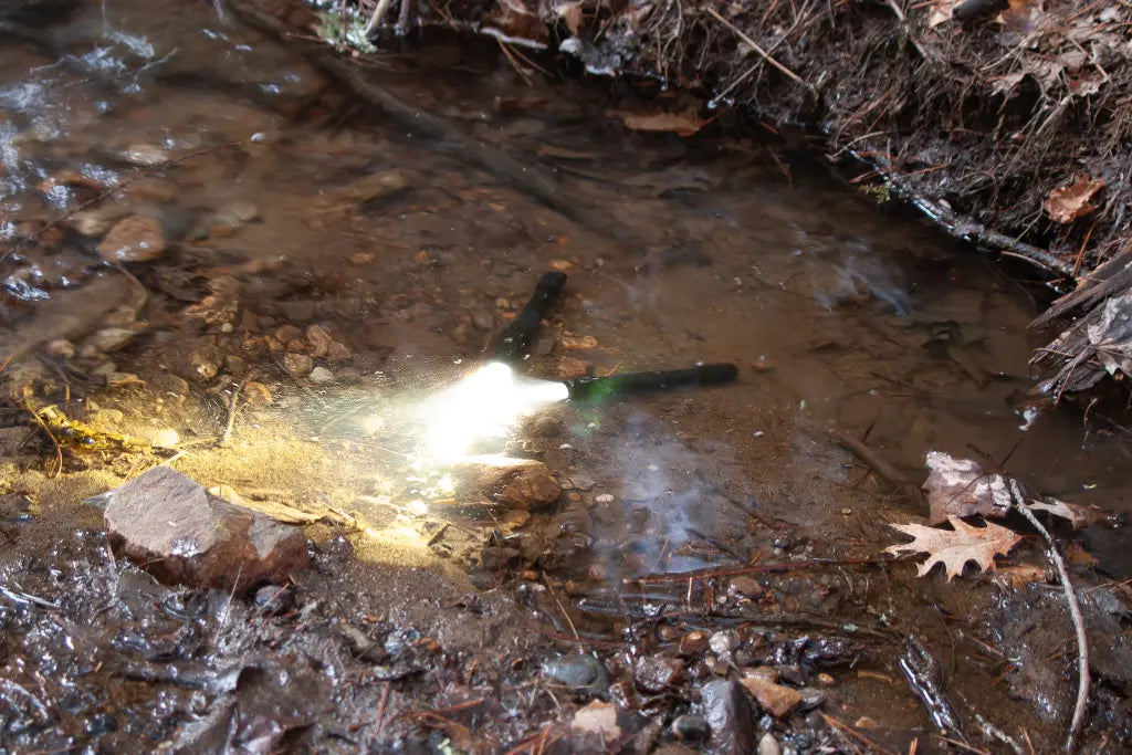 Flashlights turned on in a creek bed